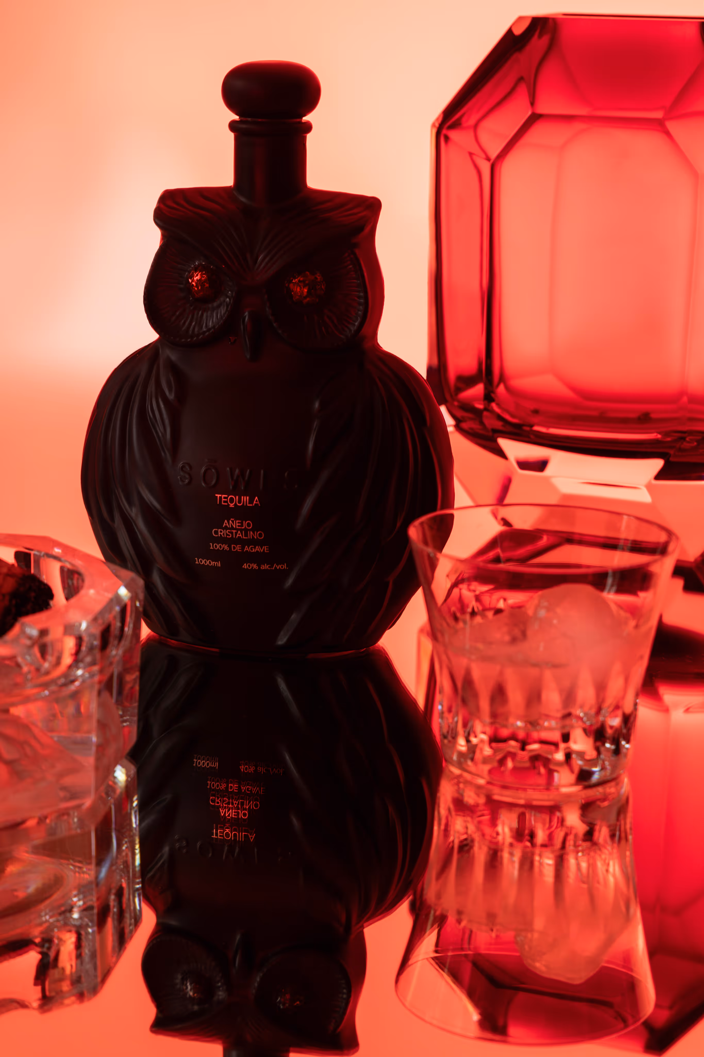 Black bottle under red lighting