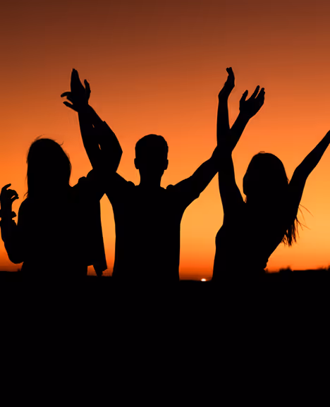 Silhouettes dancing at sunset